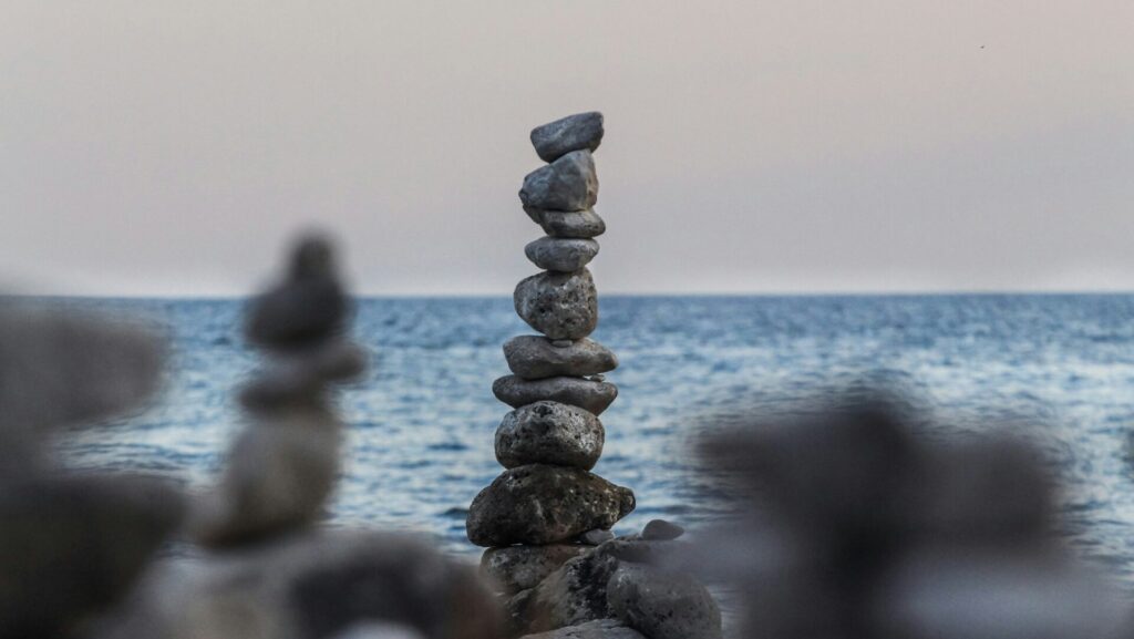 Rocks balancing near body of water